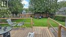 Expansive backyard featuring a wood deck, manicured lawn, and mature trees - 257 Cedar Street, Simcoe, ON  - Outdoor With Deck Patio Veranda With Backyard 