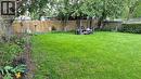 Expansive grassy yard with mature perimeter trees, a wood privacy fence, and a hedge row - 257 Cedar Street, Simcoe, ON  - Outdoor 