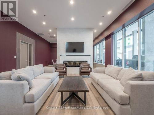 608 - 560 North Service Road, Grimsby (Grimsby Beach), ON - Indoor Photo Showing Living Room With Fireplace