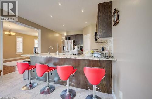 Kitchen island with a light-toned countertop and wood-finish paneling - 331 Westpark Crescent Unit# Upper, Waterloo, ON - Indoor Photo Showing Kitchen With Upgraded Kitchen