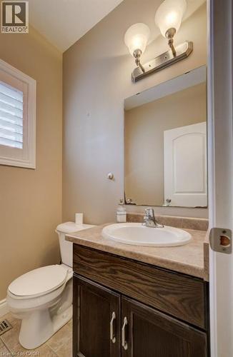 Bathroom featuring a dark wood-finish vanity with a light countertop, an oval undermount sink, and a chrome faucet - 331 Westpark Crescent Unit# Upper, Waterloo, ON - Indoor Photo Showing Bathroom