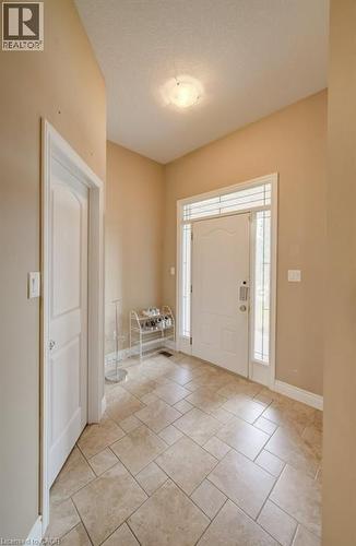 Entryway featuring neutral-toned tile flooring, a white paneled door, and a white front entry door with sidelight windows - 331 Westpark Crescent Unit# Upper, Waterloo, ON - Indoor Photo Showing Other Room