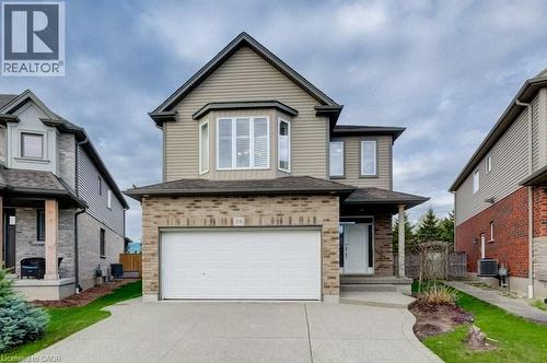 Two-story residence featuring a brick and siding exterior, an attached garage, and a concrete driveway - 331 Westpark Crescent Unit# Upper, Waterloo, ON - Outdoor With Facade