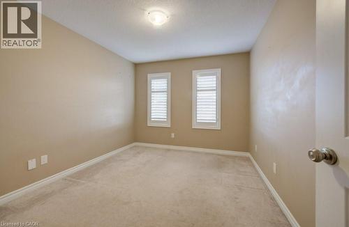 Neutral-toned room featuring two windows with white plantation shutters - 331 Westpark Crescent Unit# Upper, Waterloo, ON - Indoor Photo Showing Other Room