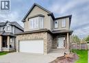 Two-story residence featuring a brick and siding exterior, an attached garage, a front entry with a covered porch, multiple windows with white shutters, and a concrete driveway - 331 Westpark Crescent Unit# Upper, Waterloo, ON  - Outdoor With Facade 