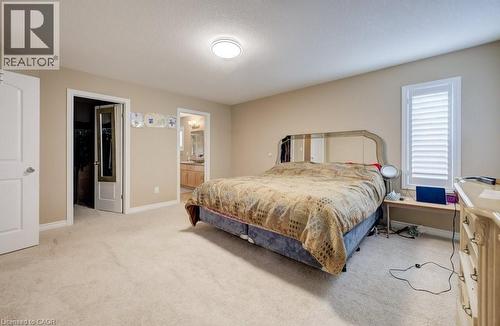 Carpeted room with neutral paint, featuring a window with white plantation shutters - 331 Westpark Crescent Unit# Upper, Waterloo, ON - Indoor Photo Showing Bedroom