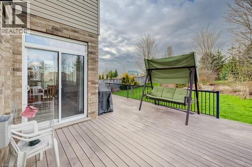 Expansive rear deck featuring composite decking, black metal railings, and a verdant lawn area - 331 Westpark Crescent Unit# Upper, Waterloo, ON - Outdoor With Deck Patio Veranda With Exterior