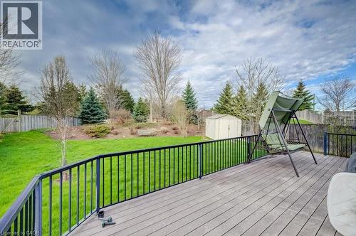 Spacious rear deck featuring wood-finish flooring and black metal railings - 331 Westpark Crescent Unit# Upper, Waterloo, ON - Outdoor