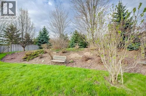 Expansive green lawn with a sloped garden bed featuring diverse mature trees and shrubs - 331 Westpark Crescent Unit# Upper, Waterloo, ON - Outdoor