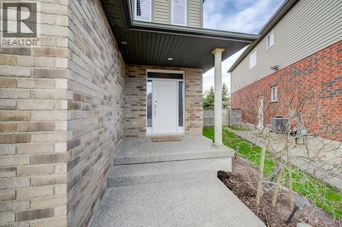 Front entrance with a white door, covered porch, and exposed aggregate concrete steps - 331 Westpark Crescent Unit# Upper, Waterloo, ON - Outdoor With Exterior