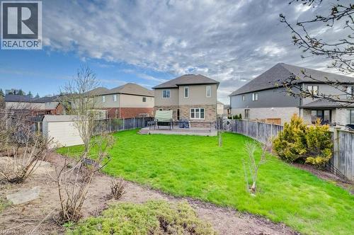 Expansive backyard featuring a lush lawn, a beige shed, and a wooden privacy fence - 331 Westpark Crescent Unit# Upper, Waterloo, ON - Outdoor With Backyard