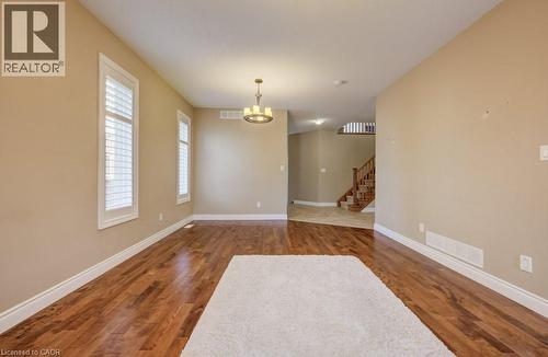Spacious room featuring rich wood-finish flooring, neutral wall tones, and white trim - 331 Westpark Crescent Unit# Upper, Waterloo, ON - Indoor Photo Showing Other Room