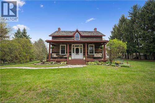 Log cabin exterior with a covered front porch and dormer window - 630 Robert Ferrie Drive, Kitchener, ON - Outdoor With Deck Patio Veranda