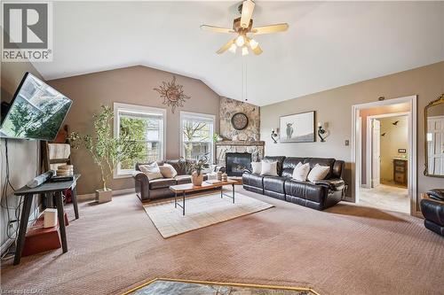 Living room featuring a vaulted ceiling and a stone-faced fireplace with a mantel - 630 Robert Ferrie Drive, Kitchener, ON - Indoor Photo Showing Living Room With Fireplace