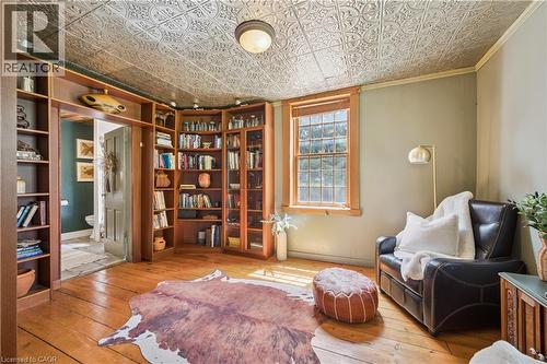 Room featuring wood-finish flooring, an ornate ceiling, and built-in shelving - 630 Robert Ferrie Drive, Kitchener, ON - Indoor