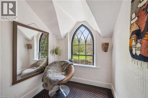 Arched window with black framing overlooking mature trees and green space - 630 Robert Ferrie Drive, Kitchener, ON - Indoor Photo Showing Other Room