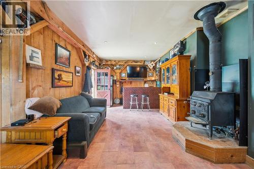 Warm wood plank walls and exposed wood beams define this spacious room - 630 Robert Ferrie Drive, Kitchener, ON - Indoor