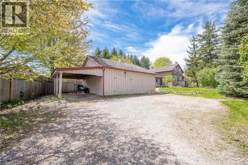 Detached garage with attached carport and gravel driveway - 630 Robert Ferrie Drive, Kitchener, ON - Outdoor