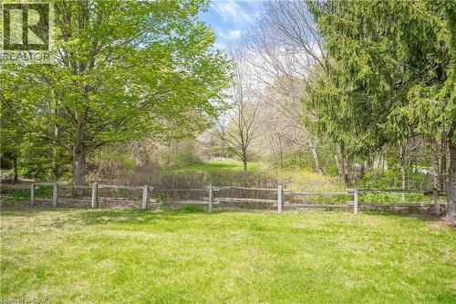 Expansive green lawn framed by a rustic split-rail fence - 630 Robert Ferrie Drive, Kitchener, ON - Outdoor With View