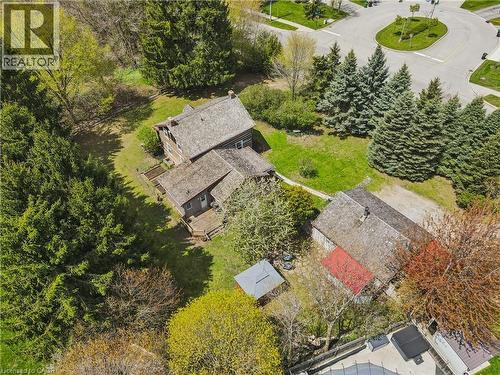 Expansive lot featuring a primary residence with a multi-level deck, a secondary structure with a red roof, and established trees providing natural screening - 630 Robert Ferrie Drive, Kitchener, ON - Outdoor With View