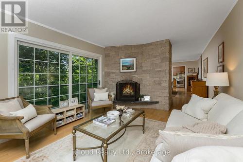 Living room is flooded with light - 487202 30 Sdrd Side Road, Mono, ON - Indoor Photo Showing Living Room With Fireplace