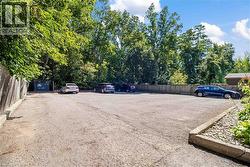 Expansive paved parking area offering multiple vehicle spaces - 