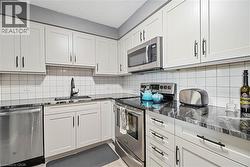 White shaker cabinetry with dark hardware - 