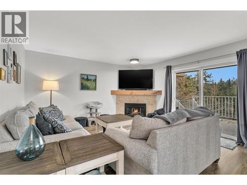 Cozy living room or make this your dining room - 3819 Glen Canyon Drive, West Kelowna, BC - Indoor Photo Showing Living Room With Fireplace