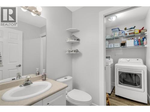 convenient half bath by the garage - 3819 Glen Canyon Drive, West Kelowna, BC - Indoor Photo Showing Laundry Room