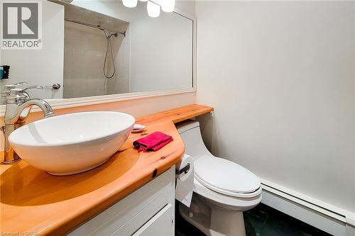 Full bathroom with a baseboard radiator, a tile shower, and vanity - 156 Park Row S, Hamilton, ON - Indoor Photo Showing Bathroom