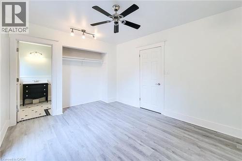 Unfurnished bedroom with wood finished floors and an ensuite bath. - 156 Park Row S, Hamilton, ON - Indoor Photo Showing Other Room