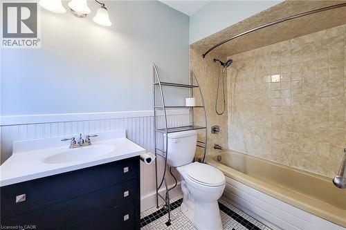 Full bathroom with wainscoting, tub / shower combination, vanity, and tile patterned flooring - 156 Park Row S, Hamilton, ON - Indoor Photo Showing Bathroom
