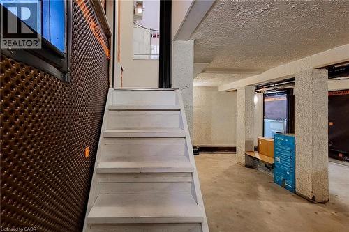 Stairs featuring concrete flooring and a textured ceiling - 156 Park Row S, Hamilton, ON - Outdoor With Deck Patio Veranda With Exterior