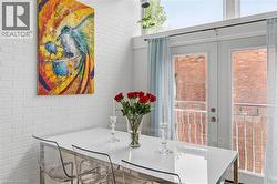 White painted brick accent wall featuring an art piece - 