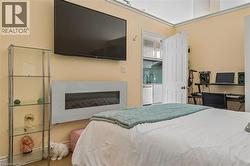 Wall-mounted media console, integrated linear fireplace, and adjacent glass display shelving - 