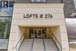 Entrance featuring stone stairs with metal handrails, a glass entry door, and ""LOFTS AT 276"" signage - 
