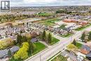 Aerial perspective showcasing a residential neighborhood with diverse architectural styles, a nearby educational facility, and substantial green spaces - 355 Guelph Avenue, Cambridge, ON 