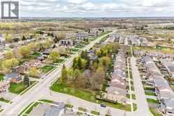Aerial view of a residential area featuring established neighborhoods, newer housing developments, and surrounding green spaces - 