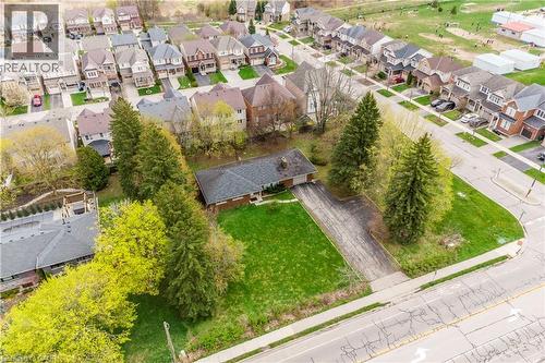 Single-story brick exterior residence featuring an attached garage, an asphalt driveway, and a shingled roof - 355 Guelph Avenue, Cambridge, ON 