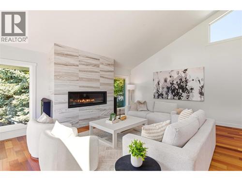 Main floor living room with access to the front deck - 2090 Bennett Road, Kelowna, BC - Indoor Photo Showing Living Room With Fireplace