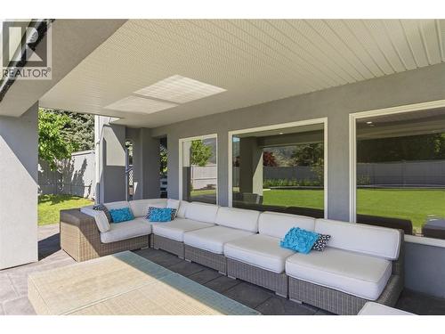 Large covered deck connected to the pool and backyard area - 2090 Bennett Road, Kelowna, BC - Outdoor With Deck Patio Veranda