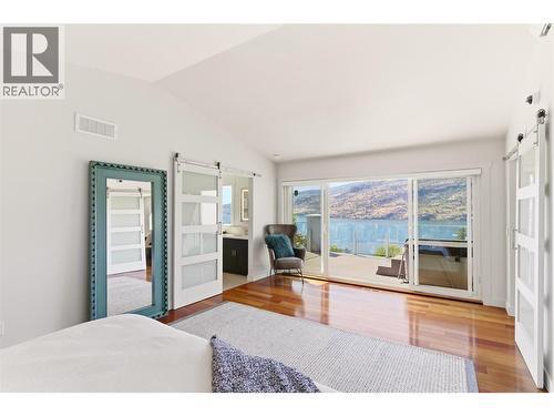 Expansive windows to enjoy the views of Okanagan Lake - 2090 Bennett Road, Kelowna, BC - Indoor Photo Showing Bedroom