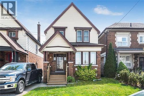 Two-story residence featuring light-colored siding and dark trim - 114 Weir Street N, Hamilton, ON - Outdoor With Facade