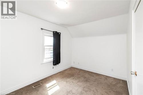 Room featuring white painted walls and a sloped ceiling - 114 Weir Street N, Hamilton, ON - Indoor Photo Showing Other Room