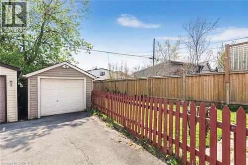 Detached garage with horizontal siding, white garage door, and a peaked roof - 114 Weir Street N, Hamilton, ON - Outdoor