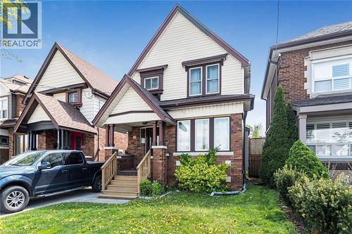 Traditional two-story residence featuring a brick facade with light-colored siding accents - 114 Weir Street N, Hamilton, ON - Outdoor With Facade