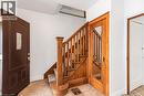 Foyer featuring a wood staircase with carpeted treads, a solid wood entry door with leaded glass insert, a wood-framed door with a full-length glass panel, and light-toned tile flooring - 114 Weir Street N, Hamilton, ON  - Indoor Photo Showing Other Room 
