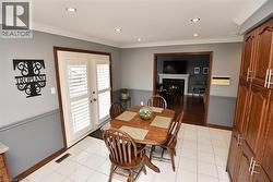 Kitchen area featuring white ceramic tile flooring, recessed lighting, and a neutral two-tone paint scheme - 