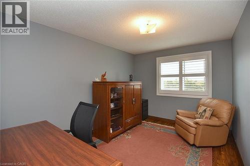 Room with wood-finish flooring, light grey walls, and a white window frame featuring white louvered shutters - 36 Tommar Place, Hamilton, ON - Indoor Photo Showing Office