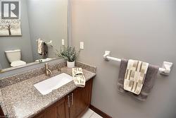 Vanity with stone-finish countertop, undermount sink, and brushed nickel faucet - 